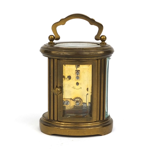 1102 - Matthew Norman of London oval brass cased carriage clock with bevelled glass and Roman numerals, 8cm... 