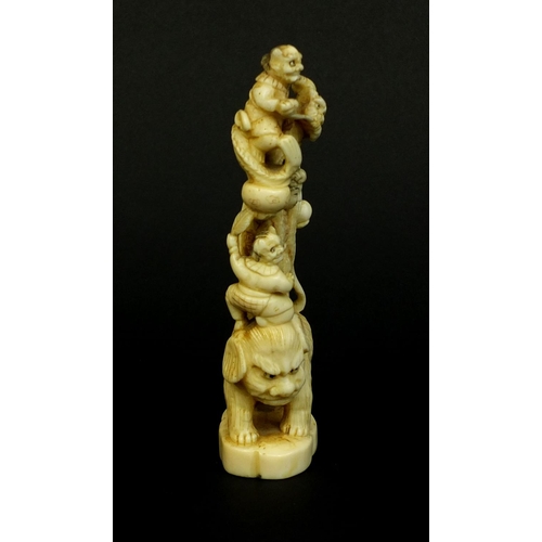 529 - Japanese carved ivory okimono of a Geisha girl standing on a lion, red insect character marks to the... 