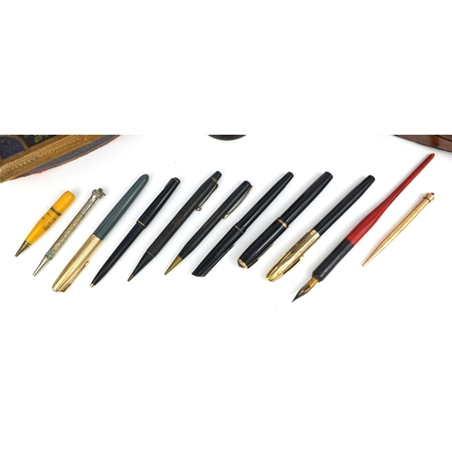 135 - Collection of pens, propelling pencils and writing equipment including two wooden ink blotters, brow... 