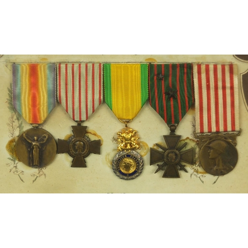 355 - Two framed displays of World War I French medals awarded to Caporal Coste Louis, each 39cm x 29cm ex... 