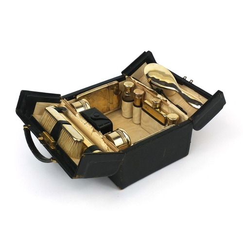 816 - Asprey London leather cased twelve piece vanity set, including a folding hand mirror, scent bottles,... 