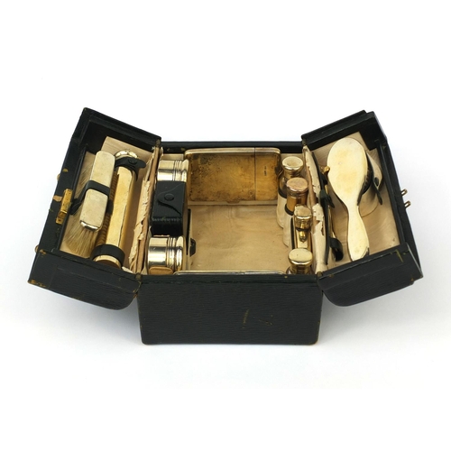 816 - Asprey London leather cased twelve piece vanity set, including a folding hand mirror, scent bottles,... 