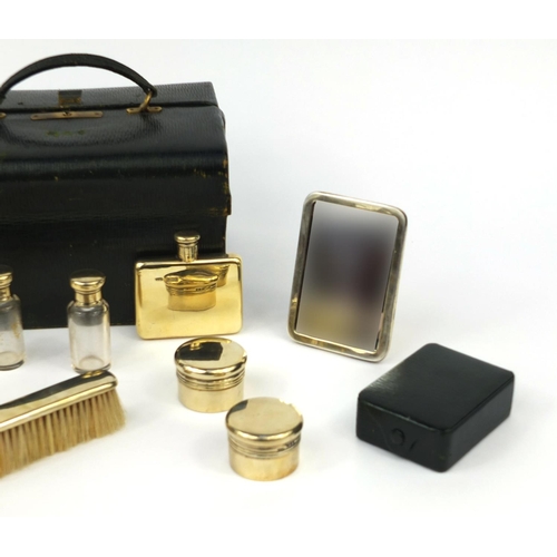 816 - Asprey London leather cased twelve piece vanity set, including a folding hand mirror, scent bottles,... 