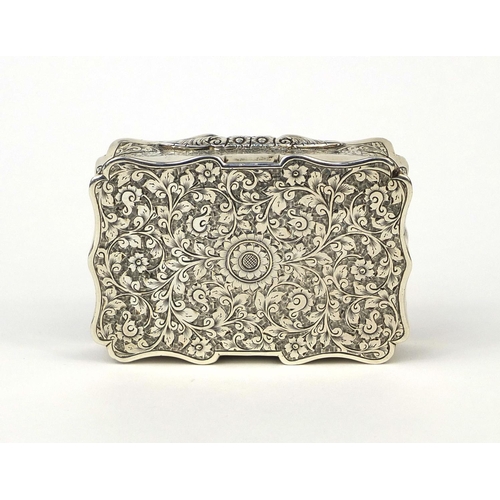 844 - Victorian rectangular silver snuff box with hinged lid and gilt interior, profusely engraved with fl... 