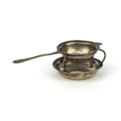 868 - Silver sifting spoon on stand, D.F London 1927, the spoon 15cm long, approximate weight 84.3g