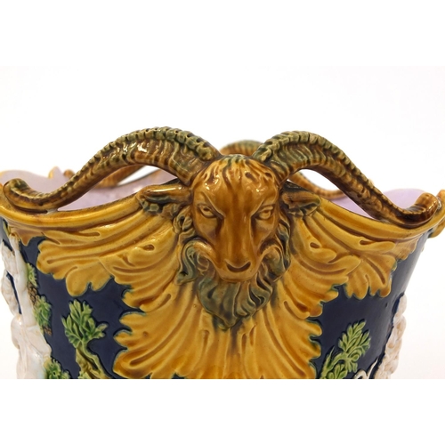 752 - Minton Majolica planter with twin ram head handles, decorated in relief with figures and rams, impre... 