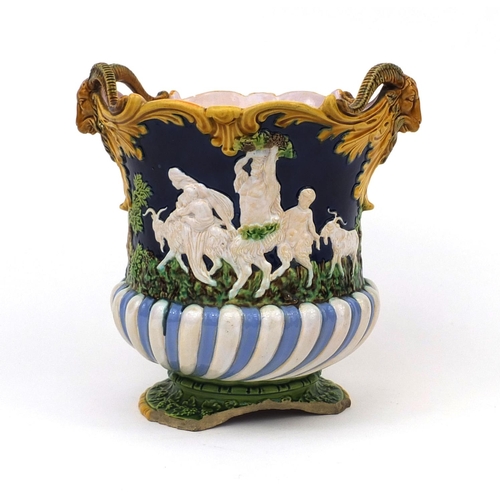 752 - Minton Majolica planter with twin ram head handles, decorated in relief with figures and rams, impre... 