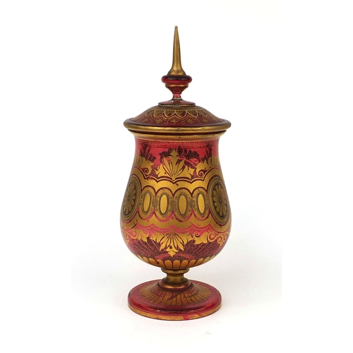 724 - Continental ruby glass vase and cover gilded with stylised floral motifs, 41cm high