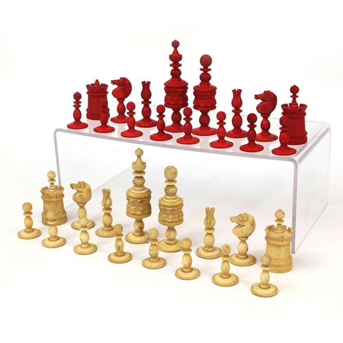 405 - Half stained turned bone chess set, the largest pieces 11cm high