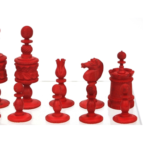 405 - Half stained turned bone chess set, the largest pieces 11cm high