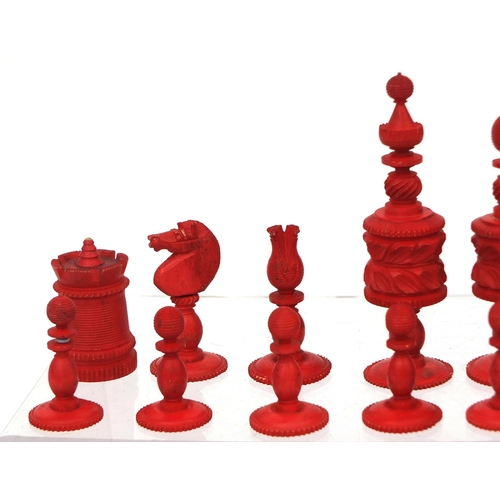 405 - Half stained turned bone chess set, the largest pieces 11cm high