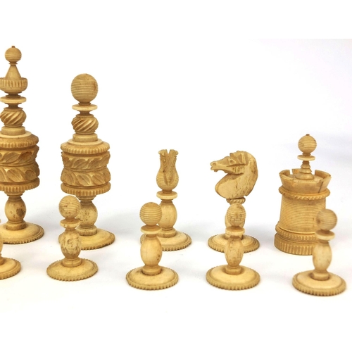 405 - Half stained turned bone chess set, the largest pieces 11cm high