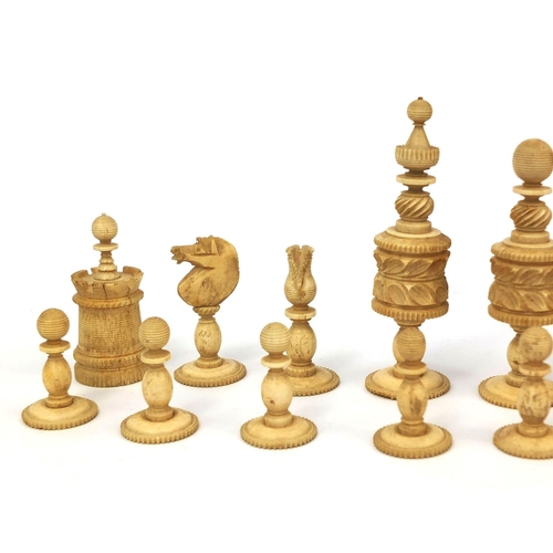 405 - Half stained turned bone chess set, the largest pieces 11cm high