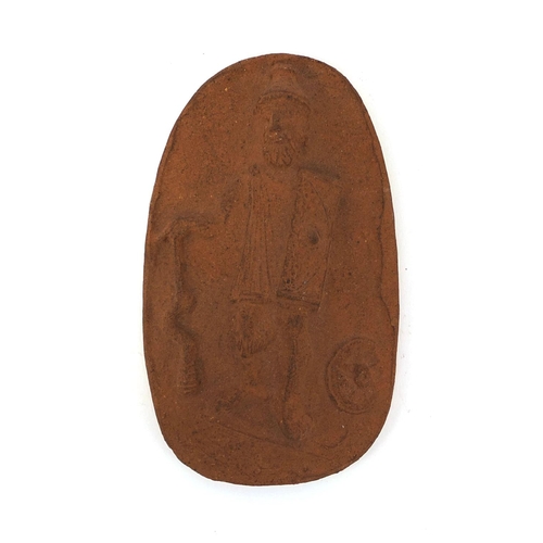 761 - Royal Doulton terracotta plaque decorated in relief with a man in armour, impressed marks to the rev... 