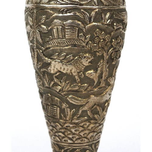 597 - Three Indian unmarked silver vases, each embossed with animals amongst trees and with frilled rims, ... 