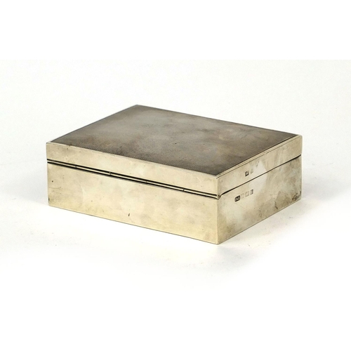 863 - Rectangular silver cigarette box, the hinged lid with engine turned decoration, P & B Birmingham 196... 