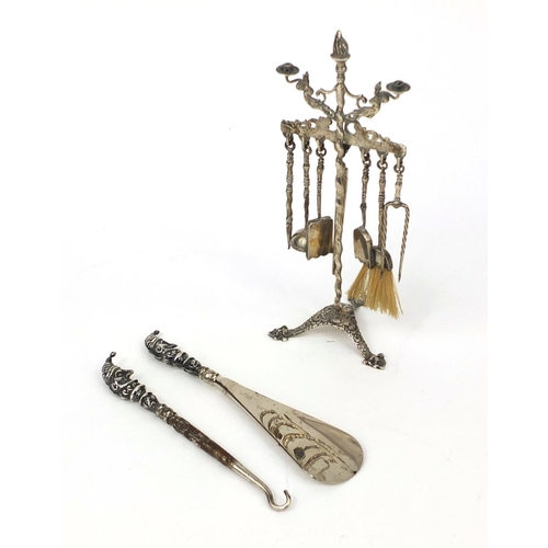 859 - Silver punch shoe horn and button hook, and a miniature continental silver dolls house companion set... 