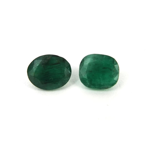 1034 - Two natural cushion cut and oval emeralds