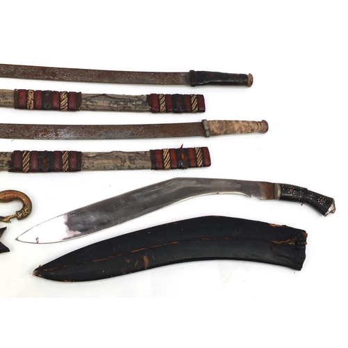 655 - Four Middle Eastern swords including two African with part leather sheaths and an Indian short sword... 