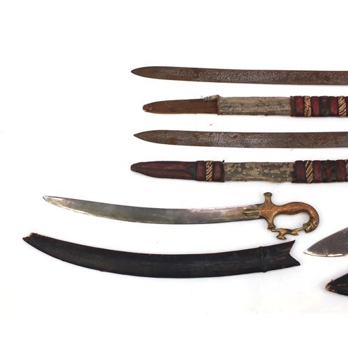 655 - Four Middle Eastern swords including two African with part leather sheaths and an Indian short sword... 