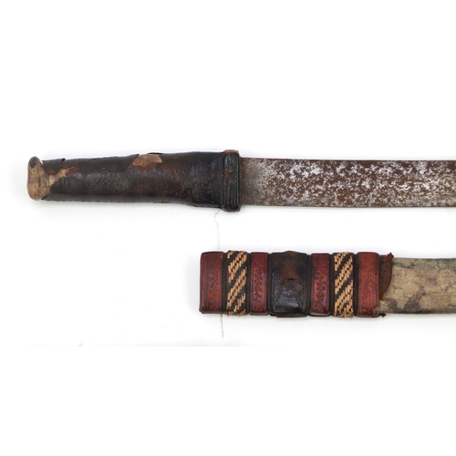 655 - Four Middle Eastern swords including two African with part leather sheaths and an Indian short sword... 