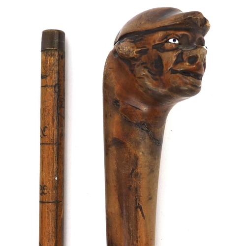 163 - Four wooden walking sticks including an ebonised silver topped example, one carved with a face and a... 