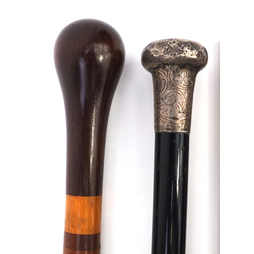 163 - Four wooden walking sticks including an ebonised silver topped example, one carved with a face and a... 