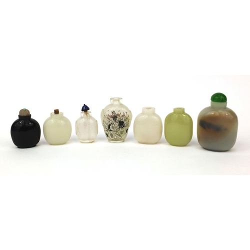 522 - Seven Chinese snuff bottles comprising six hard stone examples and an example reverse glass painted ... 