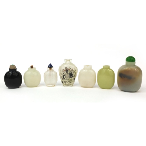 522 - Seven Chinese snuff bottles comprising six hard stone examples and an example reverse glass painted ... 