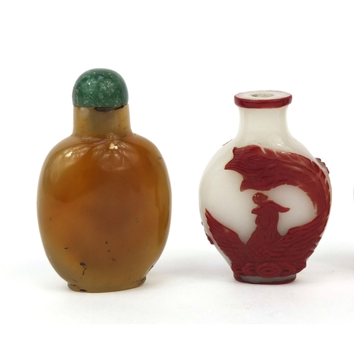 523 - Four Chinese snuff bottles comprising two cameo examples, one decorated with a dragon the other with... 