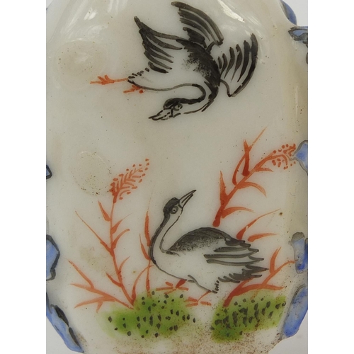 524 - Three Chinese snuff bottles comprising two porcelain examples, both hand painted with birds and one ... 