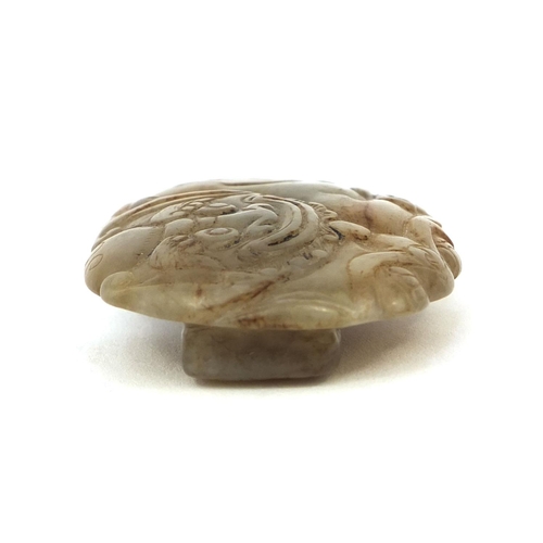 512 - Chinese russet coloured jade buckle, carved in the form of a Dog of Foo, 7cm wide