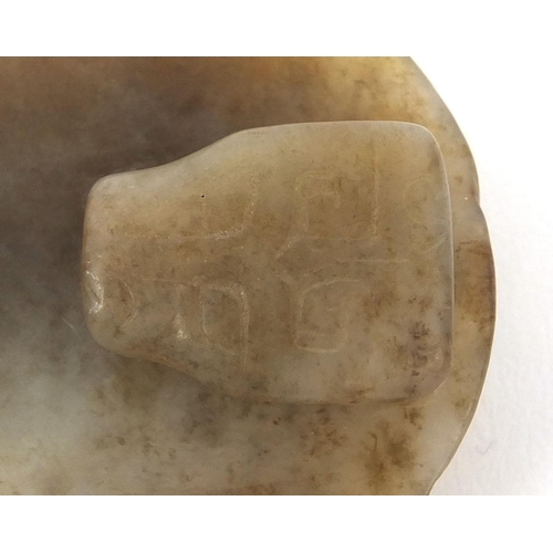 512 - Chinese russet coloured jade buckle, carved in the form of a Dog of Foo, 7cm wide