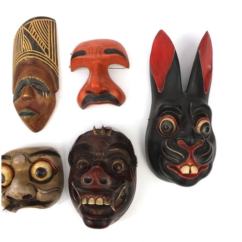 649 - Seven Balinese carved wooden face masks including examples in the form of a rabbit and a devil, the ... 