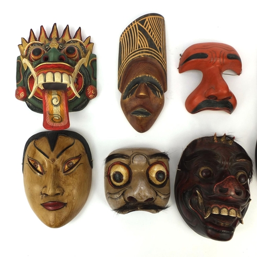 649 - Seven Balinese carved wooden face masks including examples in the form of a rabbit and a devil, the ... 