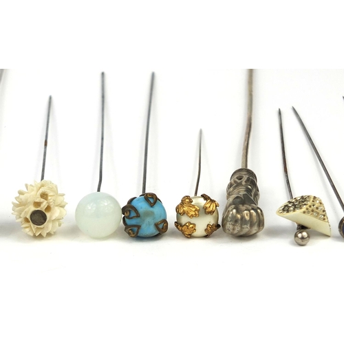 93 - Group of vintage hat pins including carved ivory, floral and enamelled examples