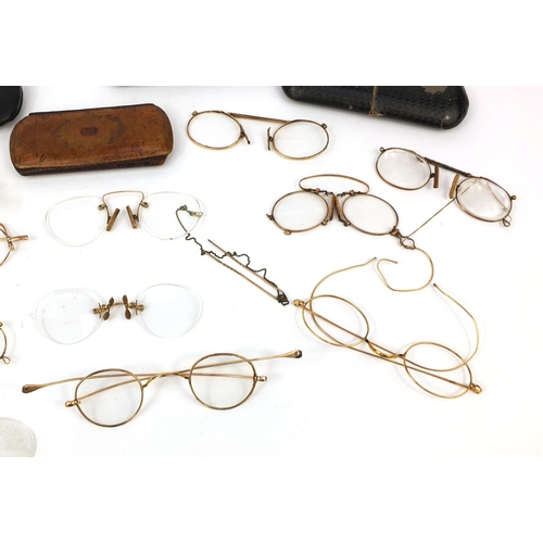 76 - Collection of vintage spectacles, mostly gold coloured metal examples, most with cases including a g... 