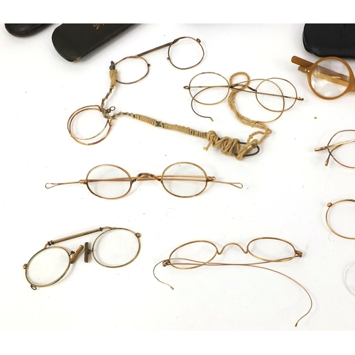 76 - Collection of vintage spectacles, mostly gold coloured metal examples, most with cases including a g... 