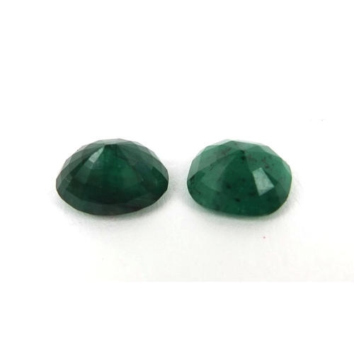 1034 - Two natural cushion cut and oval emeralds