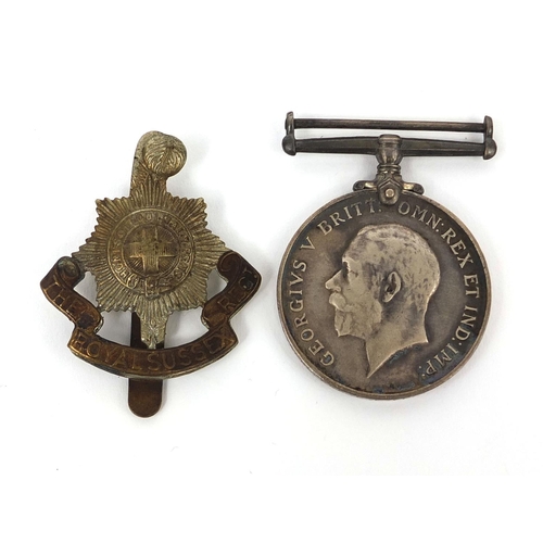 339 - British Military World War I 1914-18 war medal with Royal Sussex Regiment Cap badge, the medal award... 