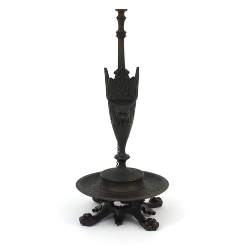 19 - Victorian bronze oil lamp with masks and lion paw feet, 25cm high