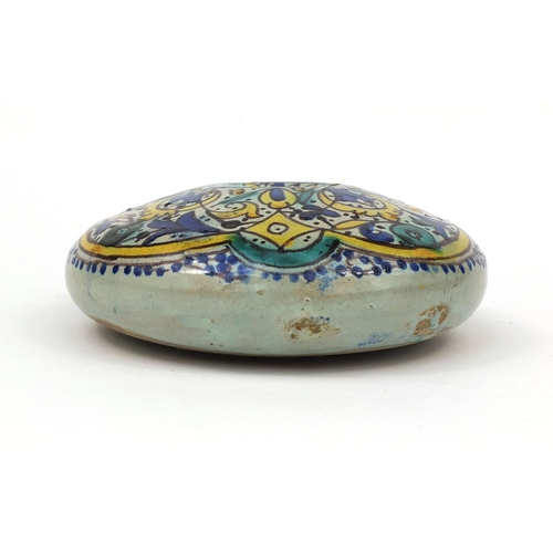 619 - Islamic iznik pottery flask with twin handles, hand painted with stylised flowers, 24cm high
