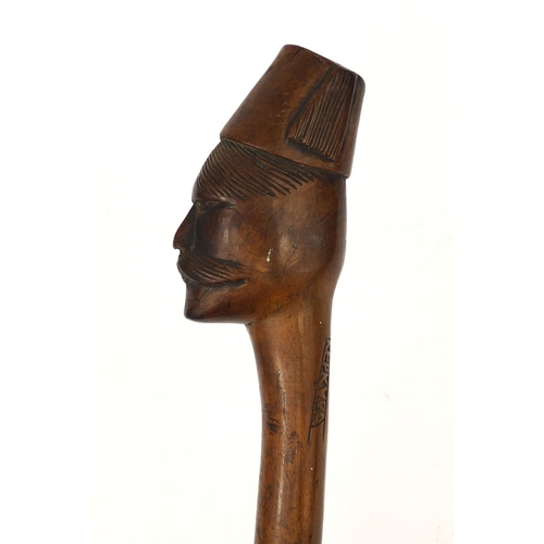 162 - Hardwood walking stick, the pommel carved in the form of a man wearing a fez, carved Kebkvpa, 95cm i... 