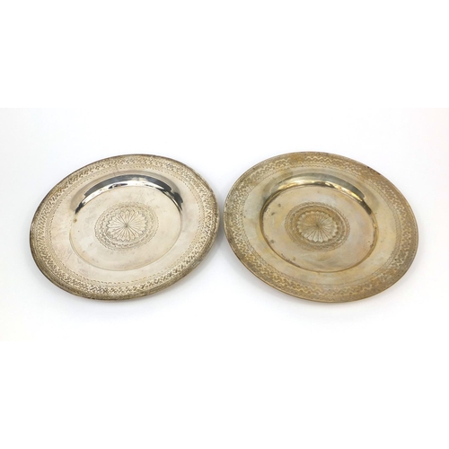 606 - Pair of Middle Eastern silver coloured metal dishes with engraved stylised decoration, each 30.5cm i... 