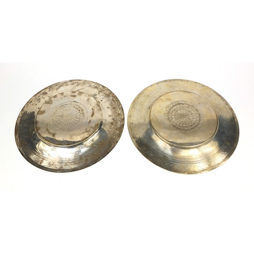 606 - Pair of Middle Eastern silver coloured metal dishes with engraved stylised decoration, each 30.5cm i... 