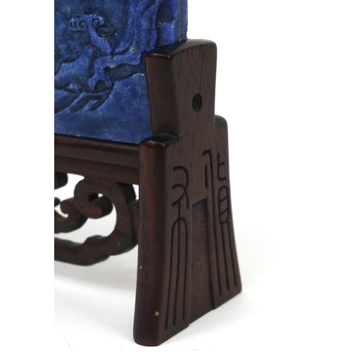 525 - Chinese Lapis Lazuli panel raised on a pierced hardwood stand, the panel carved with two cranes besi... 