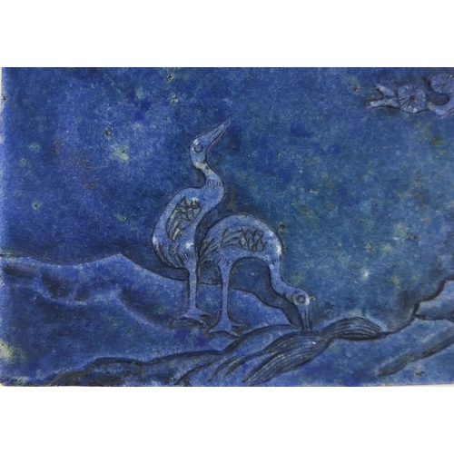 525 - Chinese Lapis Lazuli panel raised on a pierced hardwood stand, the panel carved with two cranes besi... 