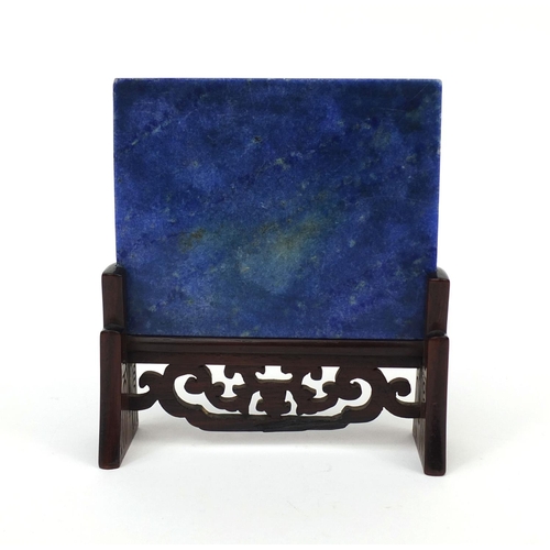 525 - Chinese Lapis Lazuli panel raised on a pierced hardwood stand, the panel carved with two cranes besi... 