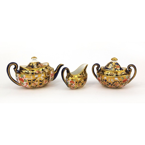 690 - Miniature Royal Crown Derby Imari pattern three piece tea set, comprising teapot, sugar bowl and mil... 