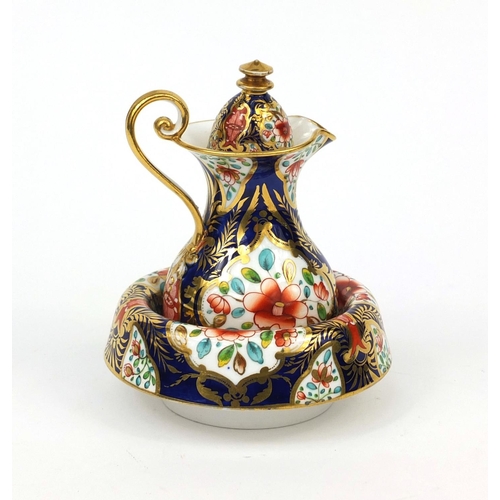 679 - Miniature Spode porcelain wash jug and basin, hand painted with panels of flowers within gilt boarde... 